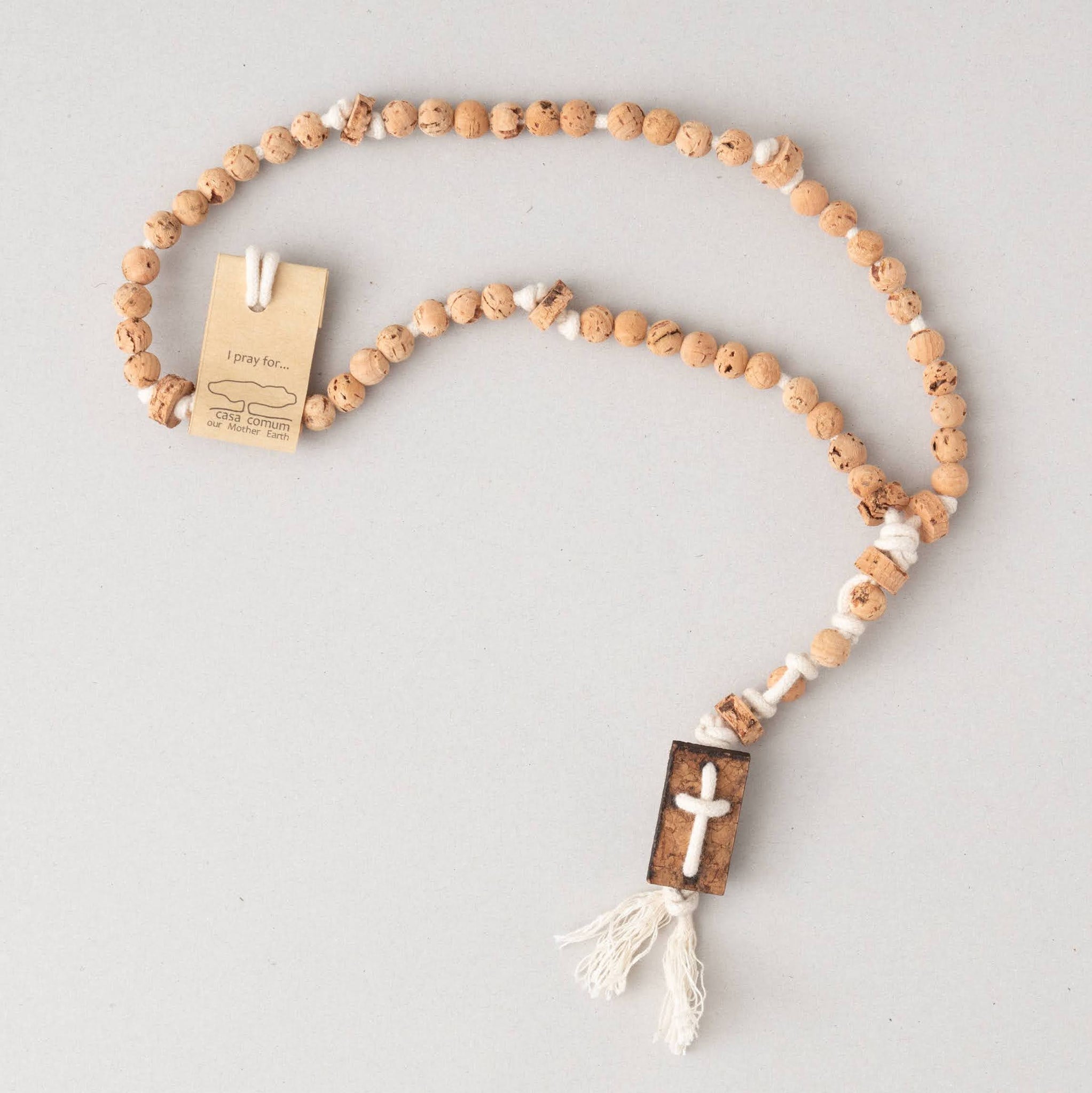 off-white cotton cord rosary with cork balls and cross with busca label