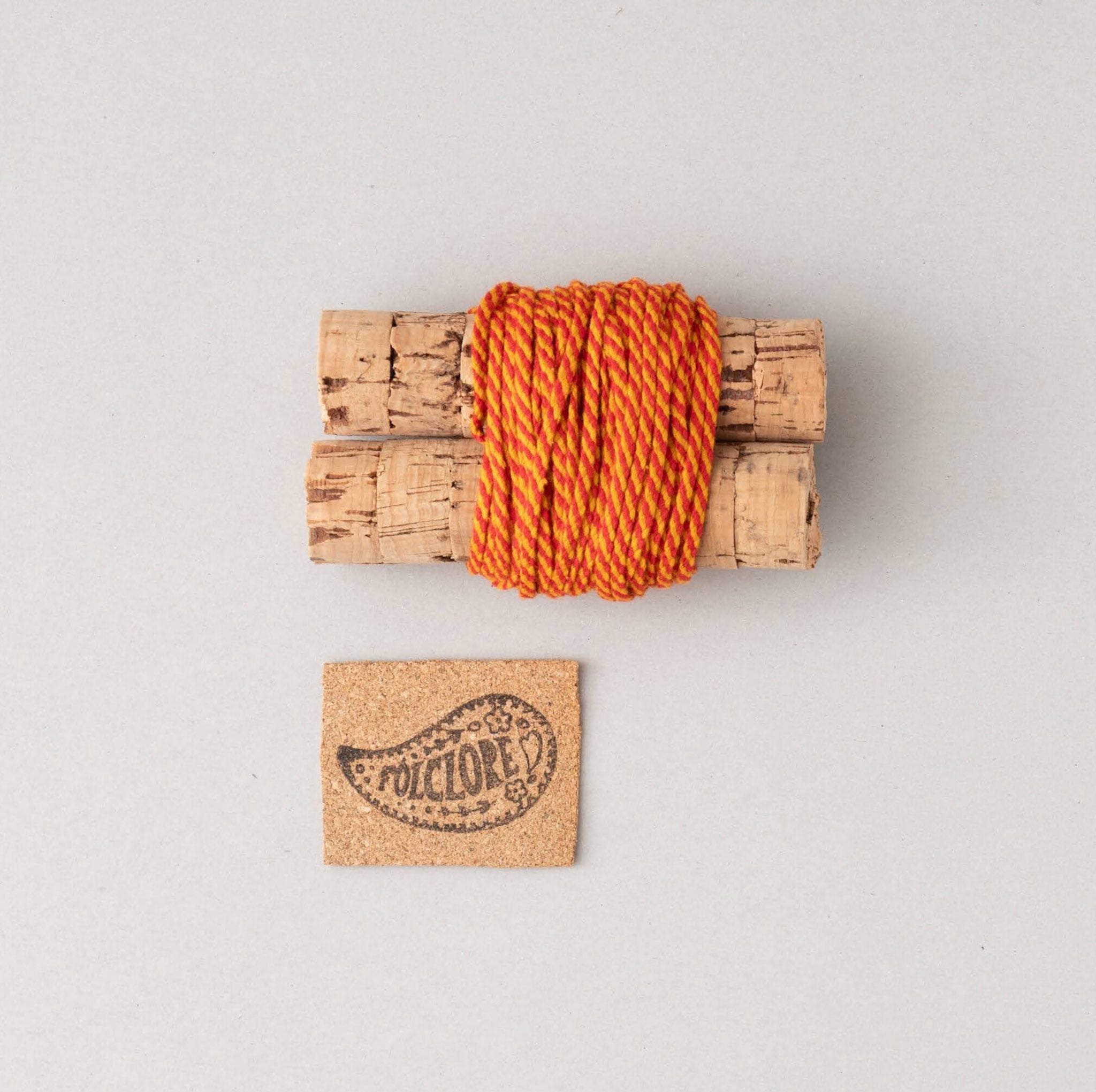 orange and red cotton cord on cork cables
