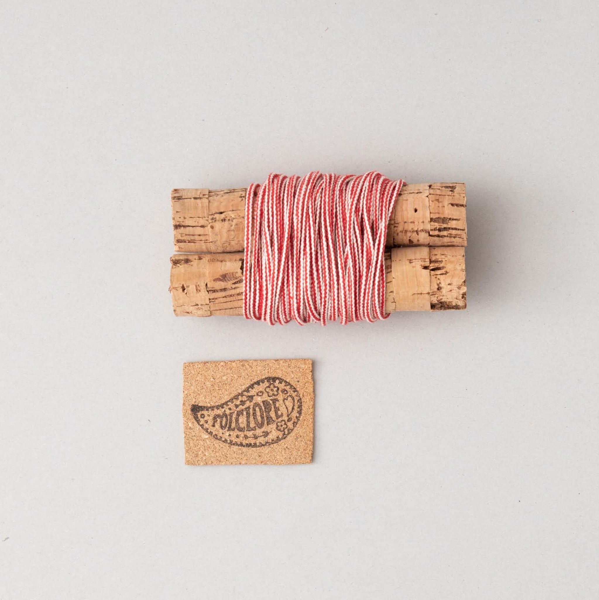 white and red cotton cord on cork cables